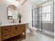 Modern bathroom with gray tile, frameless shower, and wood vanity at 501 Dargan Sw Pl, Atlanta, GA 30310