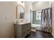 Updated bathroom with a tub shower combo, and stylish vanity at 501 Dargan Sw Pl, Atlanta, GA 30310