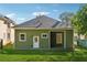 Green house exterior with a large backyard and covered patio at 501 Dargan Sw Pl, Atlanta, GA 30310