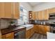 Updated kitchen features a farmhouse sink, light wood cabinets, and gray tile backsplash at 501 Dargan Sw Pl, Atlanta, GA 30310