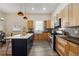 Modern kitchen with island, stainless steel appliances, and light wood cabinets at 501 Dargan Sw Pl, Atlanta, GA 30310