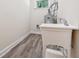 Laundry room with utility sink and modern gray flooring at 501 Dargan Sw Pl, Atlanta, GA 30310