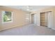 Spacious bedroom featuring two windows, neutral walls, carpet flooring, and a ceiling fan at 2620 Dr Bramblett Rd, Cumming, GA 30028