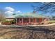 Brick ranch house with a green metal roof, large porch, and mature landscaping at 2620 Dr Bramblett Rd, Cumming, GA 30028