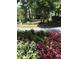 Landscaped entrance to Cross Creek community with flowering plants at 28 Glenald Nw Way, Atlanta, GA 30327
