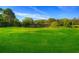 Green golf course with clubhouse in background at 28 Glenald Nw Way, Atlanta, GA 30327