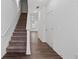 Staircase with carpet and wood-look flooring in hallway at 3087 Tarian Way, Decatur, GA 30034