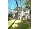 Spacious backyard with mature trees and a white two-story house at 500 Westover Nw Dr, Atlanta, GA 30305