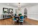 Formal dining room with round table, teal chairs, and hardwood floors at 500 Westover Nw Dr, Atlanta, GA 30305