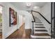Bright entryway with hardwood floors, elegant staircase, and large art piece at 500 Westover Nw Dr, Atlanta, GA 30305