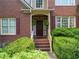 Inviting front entrance with brick steps and lush landscaping at 156 Vine Creek Dr, Acworth, GA 30101