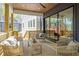 Inviting back porch features comfortable seating, stylish decor, wood ceiling and sliding glass doors, offering serene outdoor space at 160 Cedarwood Ln, Roswell, GA 30075
