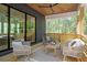 Relaxing back porch with ceiling fan, comfortable seating and wooded views, perfect for enjoying nature's tranquility at 160 Cedarwood Ln, Roswell, GA 30075
