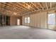 Unfinished basement with visible ceiling beams, insulated walls, and natural light from the windows at 160 Cedarwood Ln, Roswell, GA 30075