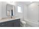 Modern bathroom with gray vanity, white subway tile, and a bathtub at 160 Cedarwood Ln, Roswell, GA 30075