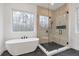 Elegant bathroom with freestanding tub and frameless shower at 160 Cedarwood Ln, Roswell, GA 30075