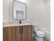 Clean bathroom with a bathtub, wood vanity, and white subway tile at 160 Cedarwood Ln, Roswell, GA 30075