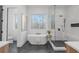 Spa-like bathroom with a freestanding tub, walk-in shower, and dark tile floors at 160 Cedarwood Ln, Roswell, GA 30075