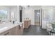 Bathroom featuring double vanities, modern lighting, soaking tub, and glass enclosed shower at 160 Cedarwood Ln, Roswell, GA 30075