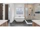 Modern bathroom with soaking tub and walk-in shower, with dark tile floors at 160 Cedarwood Ln, Roswell, GA 30075