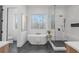 Bathroom featuring a soaking tub, glass enclosed shower, and modern fixtures at 160 Cedarwood Ln, Roswell, GA 30075