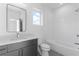 Modern bathroom featuring a sleek vanity, rectangular mirror, and a shower-tub combination at 160 Cedarwood Ln, Roswell, GA 30075