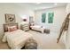 Bright bedroom features two twin beds, stylish decor, and natural light at 160 Cedarwood Ln, Roswell, GA 30075