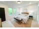 Serene bedroom with a soft rug, wood headboard and bench seating at 160 Cedarwood Ln, Roswell, GA 30075