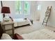 Bright bedroom featuring hardwood floors, plush carpet, and two twin beds at 160 Cedarwood Ln, Roswell, GA 30075