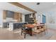 Open-concept kitchen and dining area featuring stylish light fixture, large windows, and hardwood floors at 160 Cedarwood Ln, Roswell, GA 30075