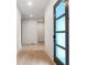 Light and airy entry hall with light wood floors and modern door at 160 Cedarwood Ln, Roswell, GA 30075