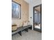 Modern entryway with built-in bench, wood wall, and grey tile floor at 160 Cedarwood Ln, Roswell, GA 30075