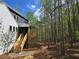 Spacious back deck and modern home exterior, showcasing lush green forest views from elevated wood deck at 160 Cedarwood Ln, Roswell, GA 30075