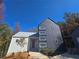 Modern two-story home with white and dark blue siding, metal roof, and landscaping at 160 Cedarwood Ln, Roswell, GA 30075