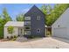 Modern home featuring unique architectural design, with a two-car garage, and surrounded by mature trees at 160 Cedarwood Ln, Roswell, GA 30075