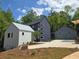 Modern home with a two-car garage, white siding, black trim, and a beautiful lawn in a sunny location at 160 Cedarwood Ln, Roswell, GA 30075