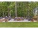 Picturesque fire pit area with comfortable seating amidst lush trees, ideal for relaxing evenings at 160 Cedarwood Ln, Roswell, GA 30075