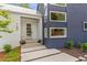 Beautiful modern home featuring a stylish front door, and neat landscaping at 160 Cedarwood Ln, Roswell, GA 30075