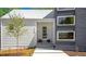 Charming modern home featuring a stylish front door, clean lines, and neat landscaping at 160 Cedarwood Ln, Roswell, GA 30075