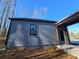 Gray siding detached garage with a modern door and window at 160 Cedarwood Ln, Roswell, GA 30075