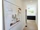 Bright hallway with hardwood floors, modern art, and view of a staircase at 160 Cedarwood Ln, Roswell, GA 30075