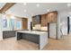 Modern kitchen with island, gray and wood cabinets, and stainless steel appliances at 160 Cedarwood Ln, Roswell, GA 30075