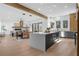 Open floorplan with a kitchen featuring a large island, stainless appliances, and a living/dining area at 160 Cedarwood Ln, Roswell, GA 30075