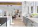 Open-concept kitchen with an island, flowing into the dining and living areas featuring a fireplace at 160 Cedarwood Ln, Roswell, GA 30075