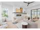 Bright, modern living room with a fireplace, comfortable seating, and views of the outdoors at 160 Cedarwood Ln, Roswell, GA 30075