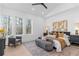 The airy main bedroom has tree views, a sitting area, and stylish modern decor at 160 Cedarwood Ln, Roswell, GA 30075
