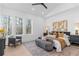 Main bedroom with a king-size bed, sitting area, and large windows at 160 Cedarwood Ln, Roswell, GA 30075