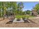 Charming community outdoor space with gravel, fire pit, seating, and a serene wooded backdrop at 160 Cedarwood Ln, Roswell, GA 30075
