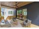 Inviting covered patio with comfortable seating, ceiling fan, and view of the yard at 160 Cedarwood Ln, Roswell, GA 30075