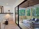 Inviting covered patio with comfortable seating, offering an indoor/outdoor living experience with wooded view at 160 Cedarwood Ln, Roswell, GA 30075